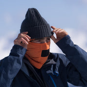 a man wearing a Harvest orange Merino Wool Balaclava and a Ridge beanie