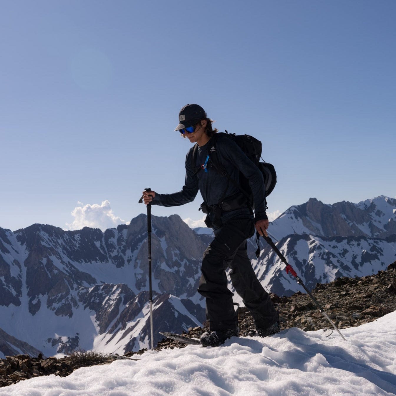 a man splitboarding in an Aspect base layer shirt