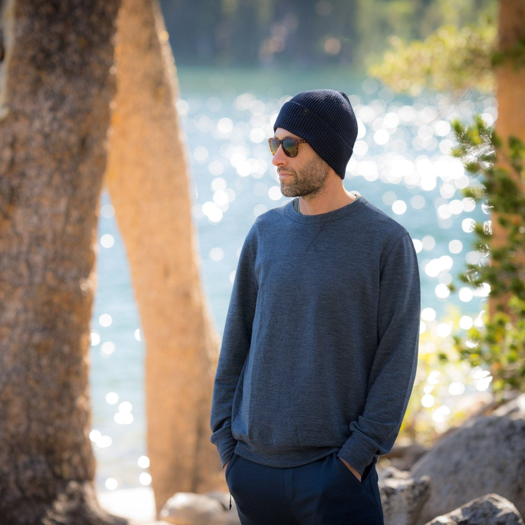 A man wearing a beanie and the Ridge Natural Tencel Crew Sweatshirt by a lake in Mammoth