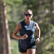 a woman running in a a woman hiking wearing a Natural Tencel Merino Tank