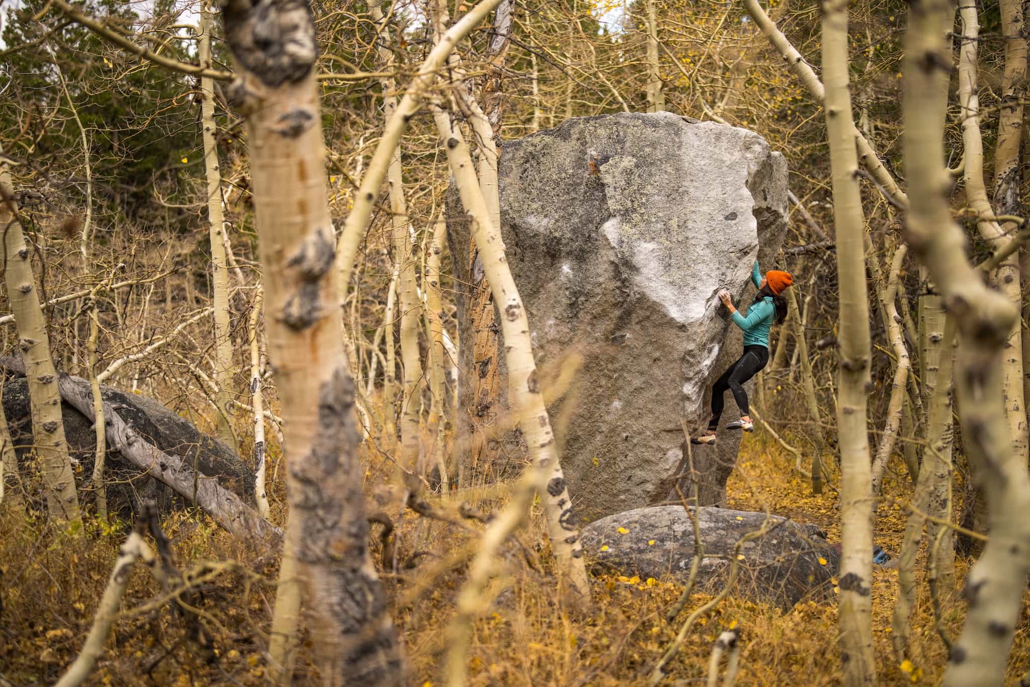 a woman boulders in the fall in an area near Mammoth Lakes