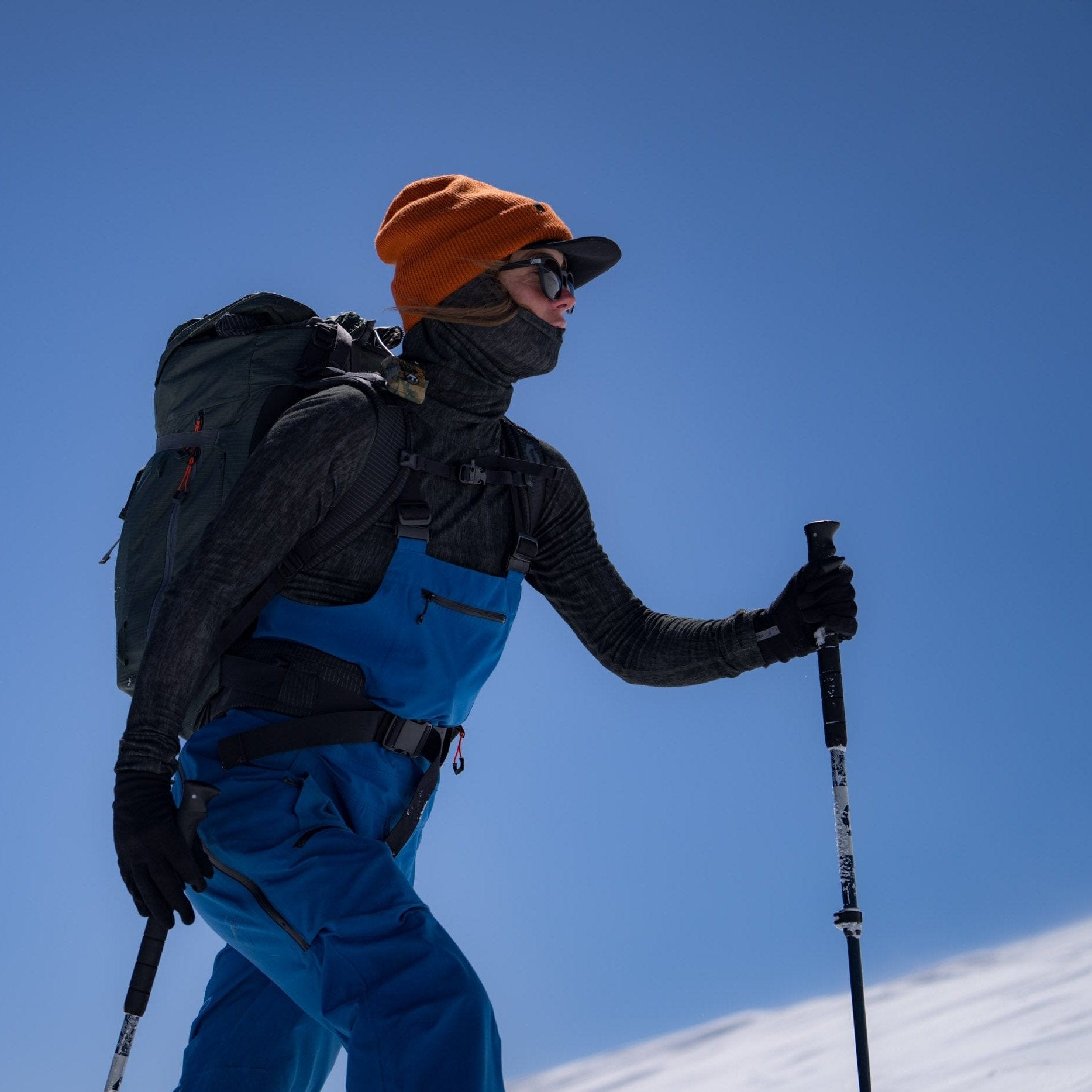 Molly Armanino skinning up a hill in Ridge Aspect base layers