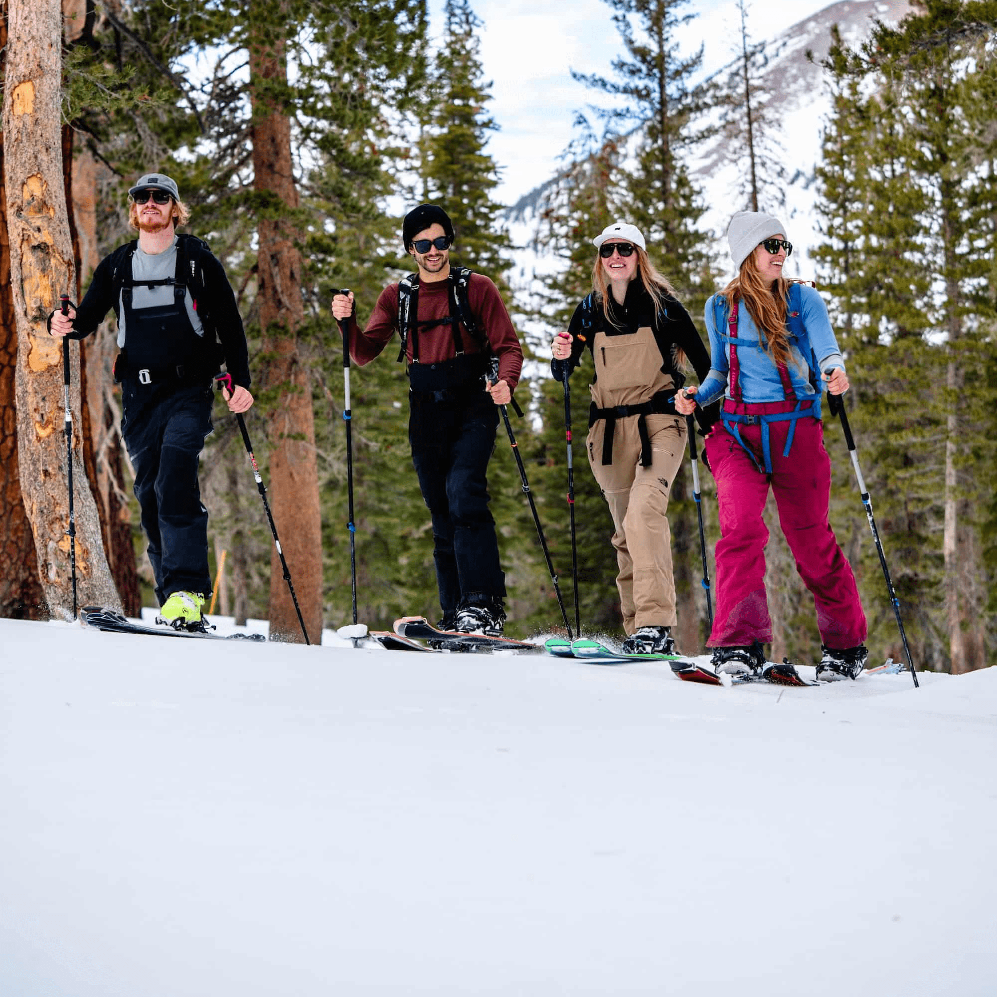 four skiers skinning around Mammoth wearing Ridge base layers