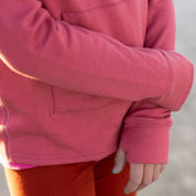 a girl wearing a Ridge Kids' Hyde Merino Hoodie