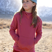 a girl wearing a Ridge Kids' Hyde Merino Hoodie