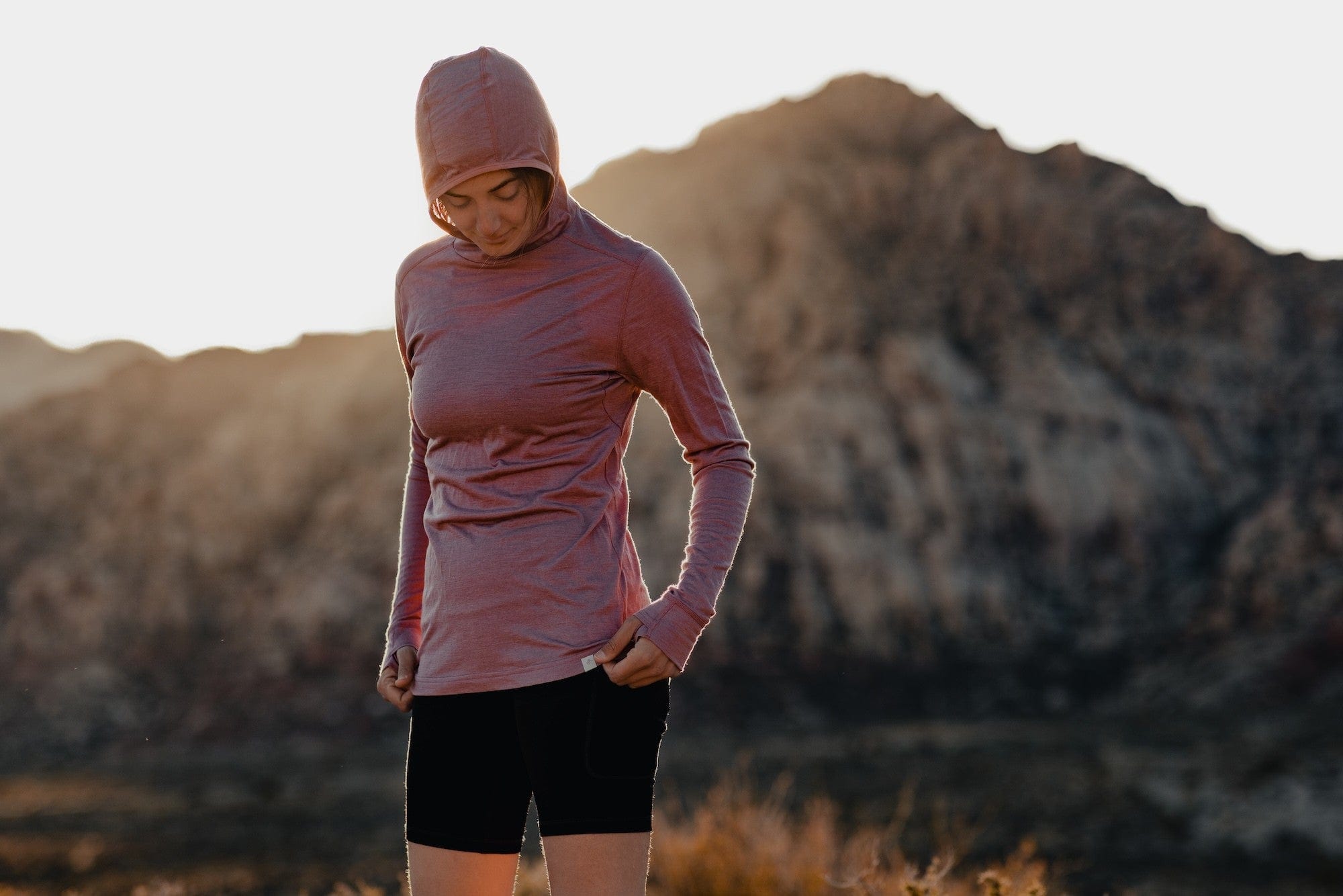 a woman wearing a Ridge Pursuit Ultralight Running Hoodie