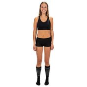 a woman wearing a Ridge Merino Seamless Sports Bra and Ridge Boy Shorts in black