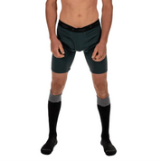 a man wearing Ridge Merino Long Boxer Briefs in Old Growth with Ritter Ski Socks