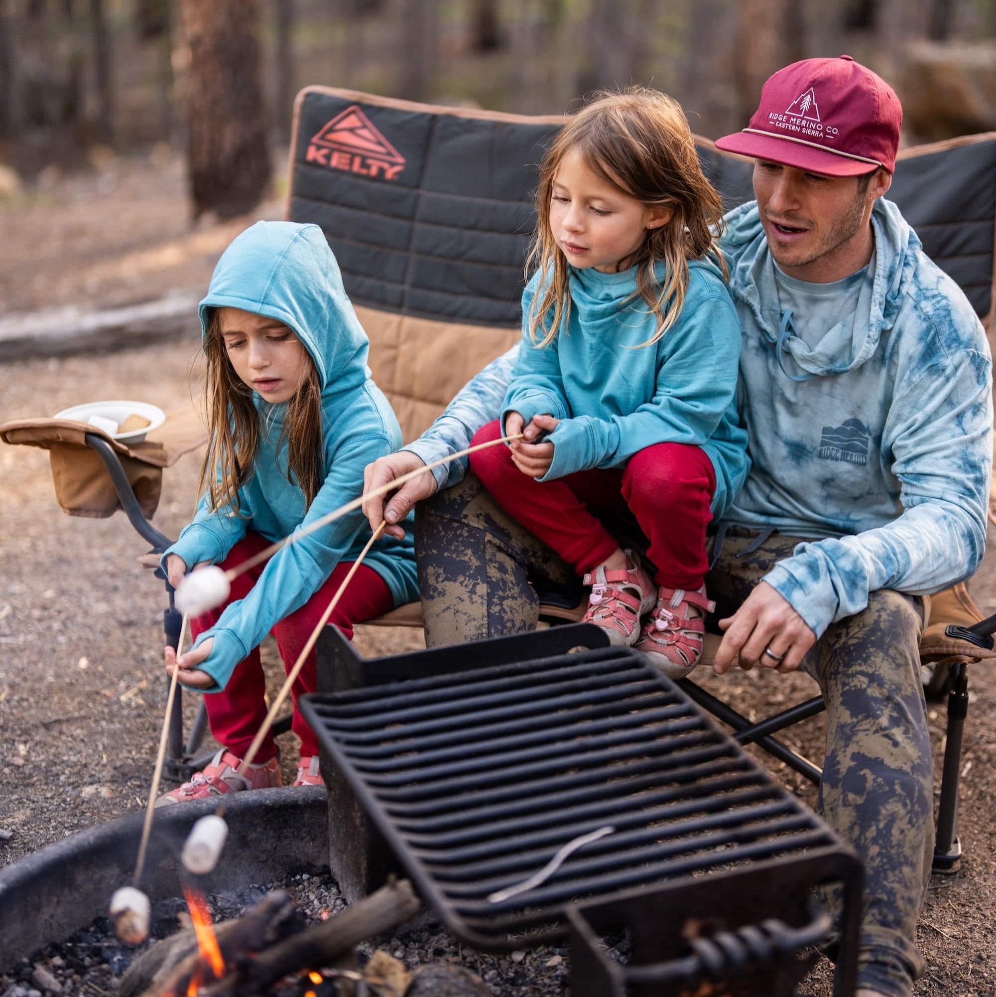 girls in Ridge Hyde Hoodies roast marshmallows with their dad at camp
(who's wearing a Ridge Tie-Dye Solstice Sun Hoodie)