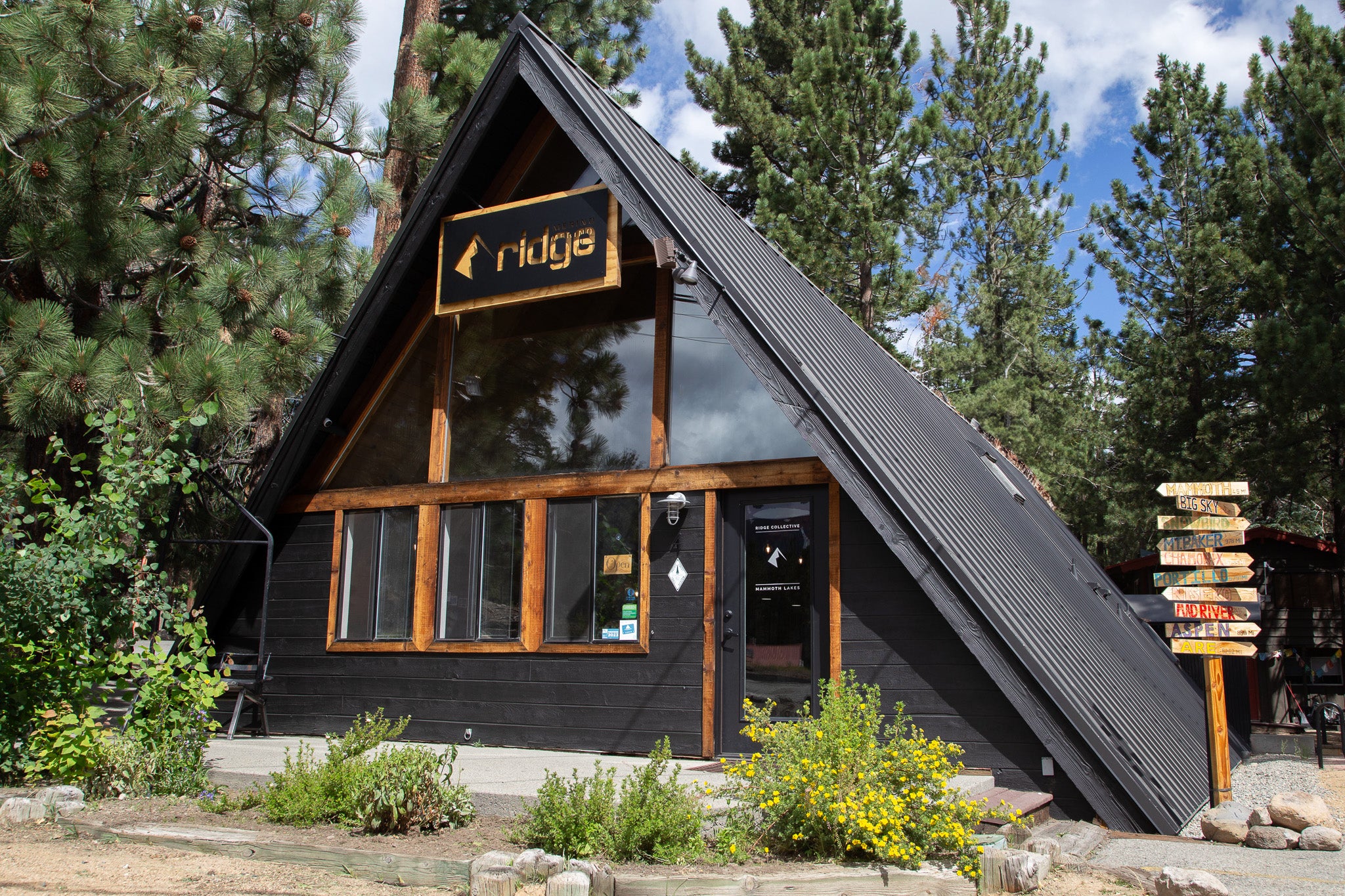 Ridge Merino headquarters in Mammoth Lakes: a black A-frame building with reddish wood trim