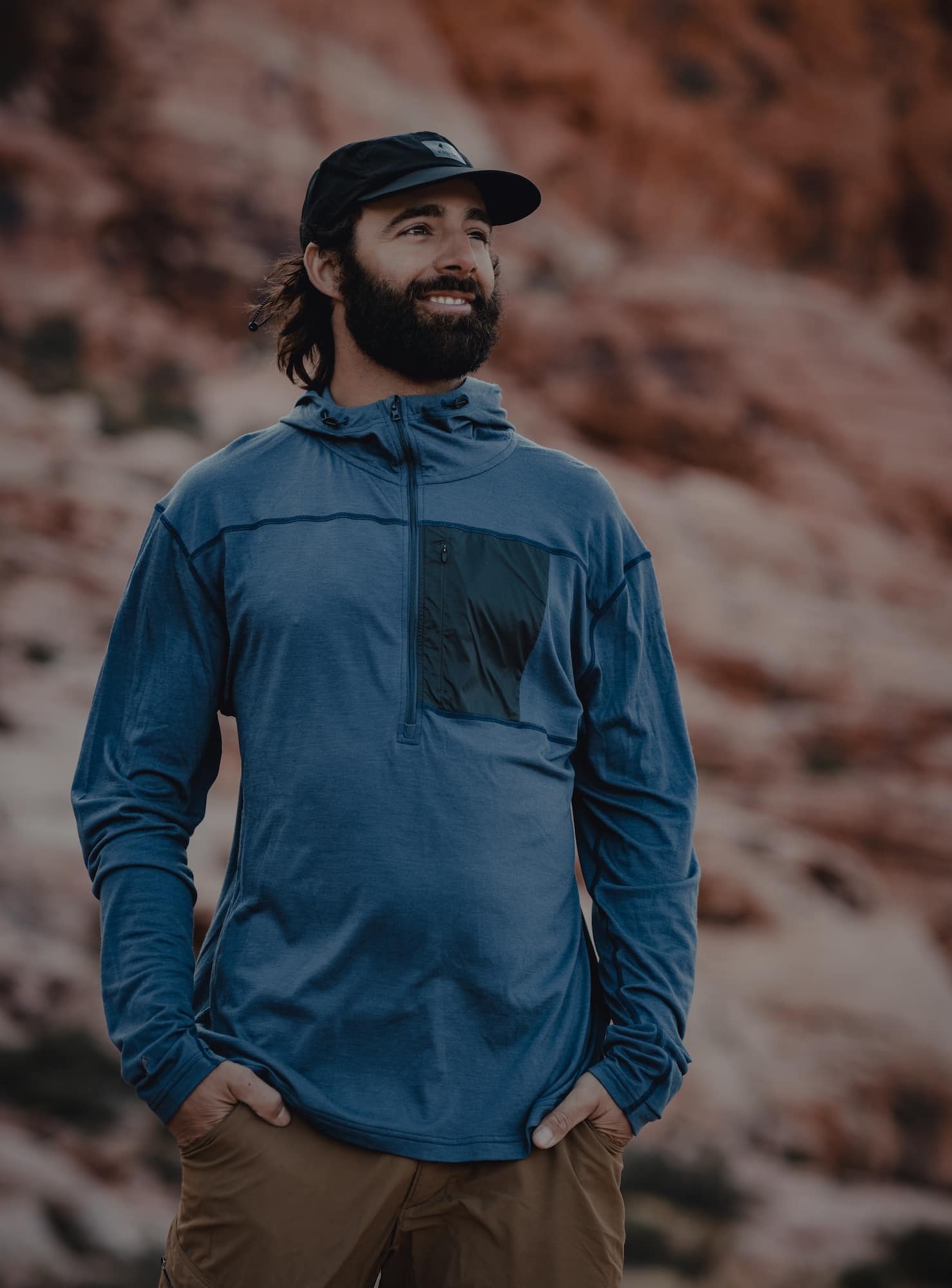 a man wearing a Solstice Pro Merino Sun Hoodie