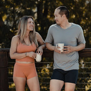a woman and a man wearing Ridge underwear and tees drink coffee on the porch