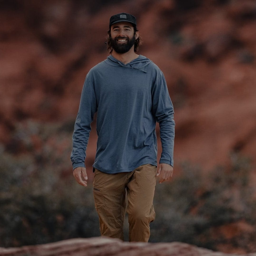 a man wearing a Ridge Merino wool sun hoodie