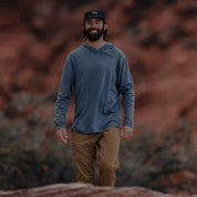 a man wearing a Ridge Merino wool sun hoodie