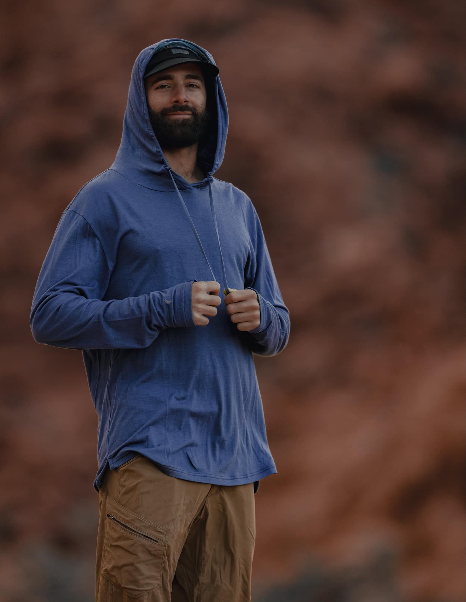 a man wearing a Ridge Merino Solstice Sun Hoodie