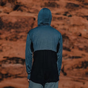 a man wearing a Pursuit Pro Ultralight Merino Hoodie from the back showing the mesh
