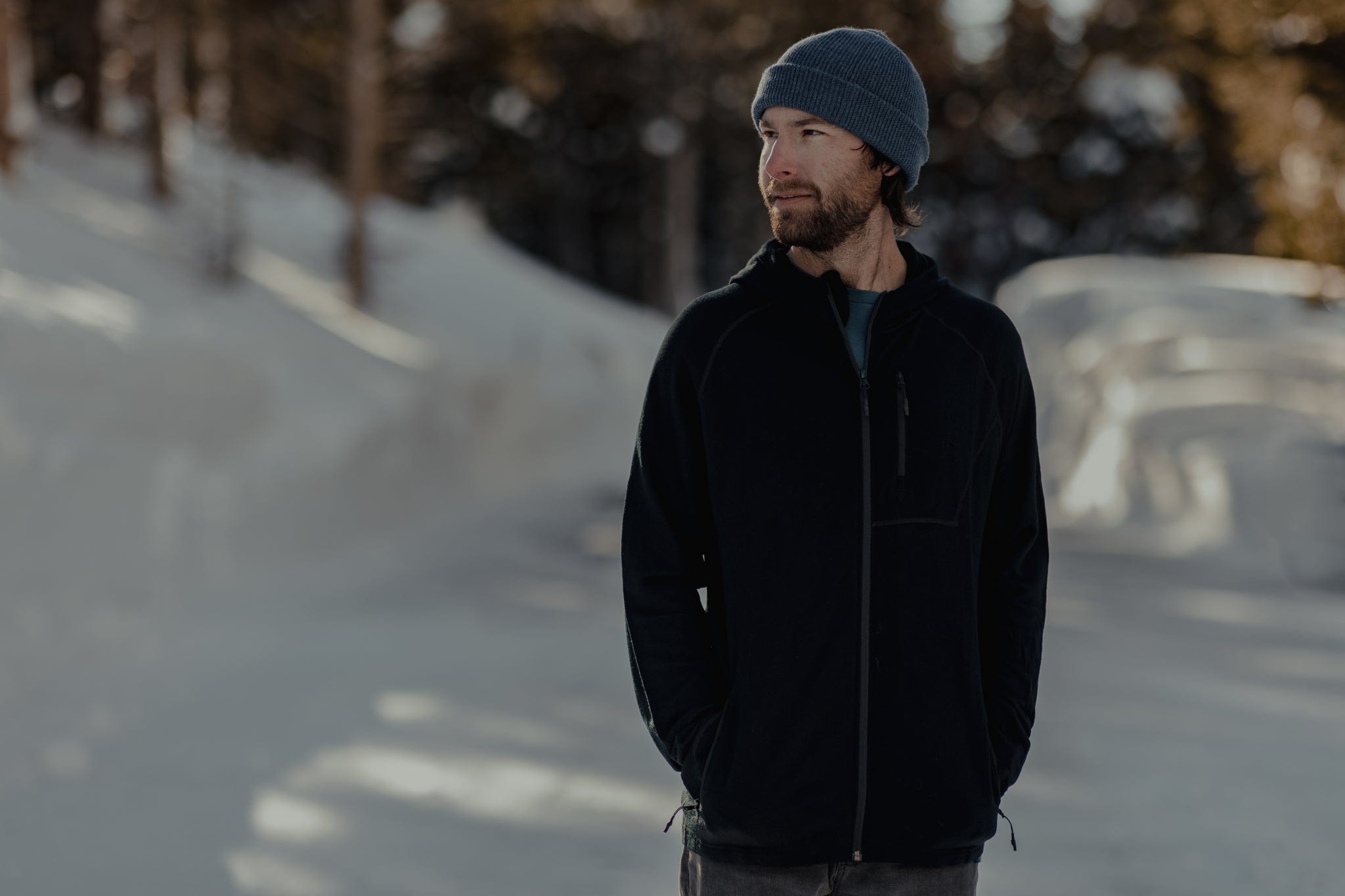 a man wearing a Ridge Merino Hyde Hoodie made of 100% Merino wool