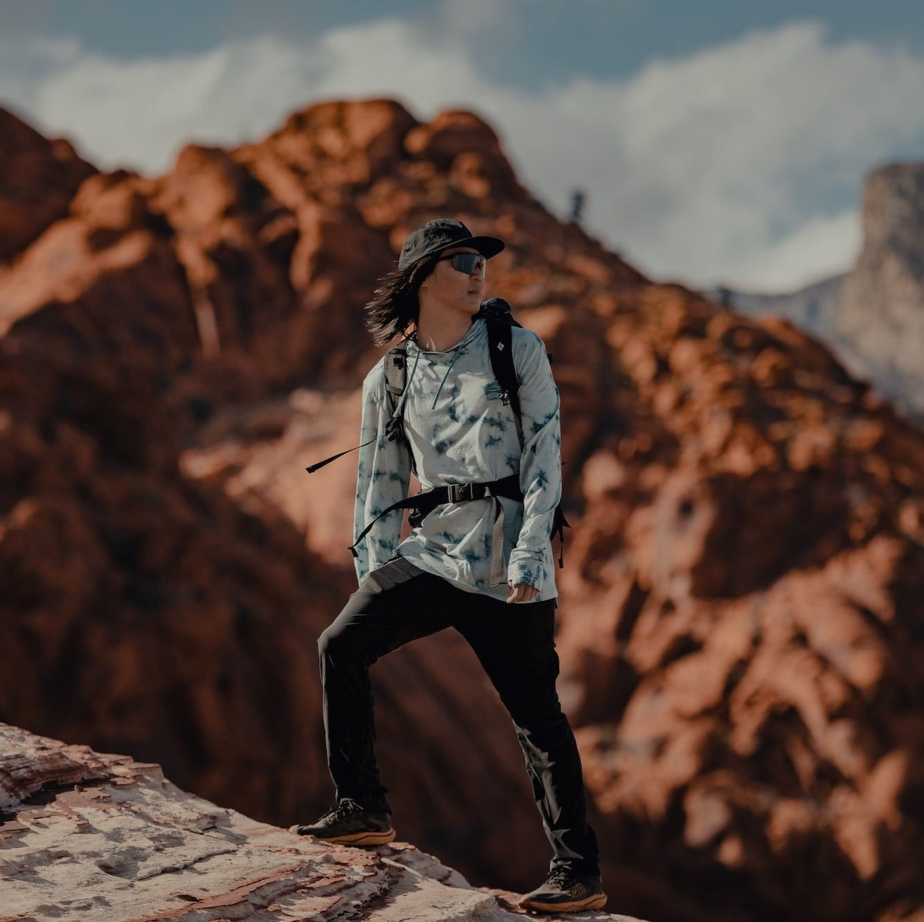 a man hiking in a Ridge Merino Solstice Sun Hoodie