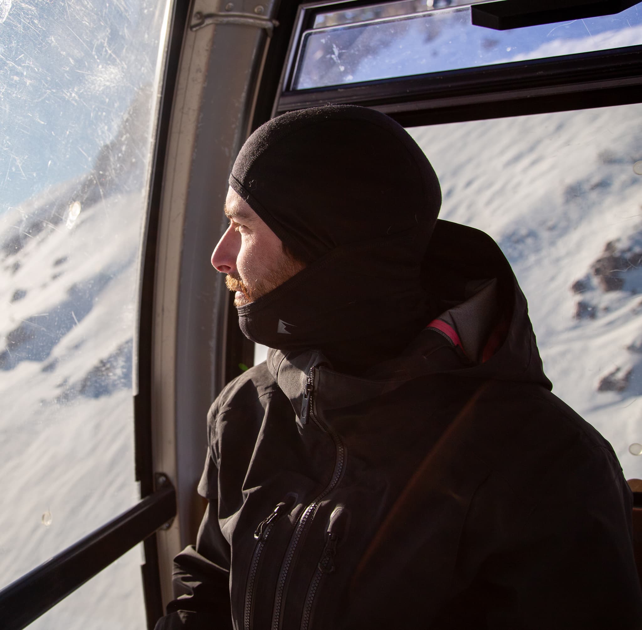 a skier wearing a Merino balaclava on a gondola