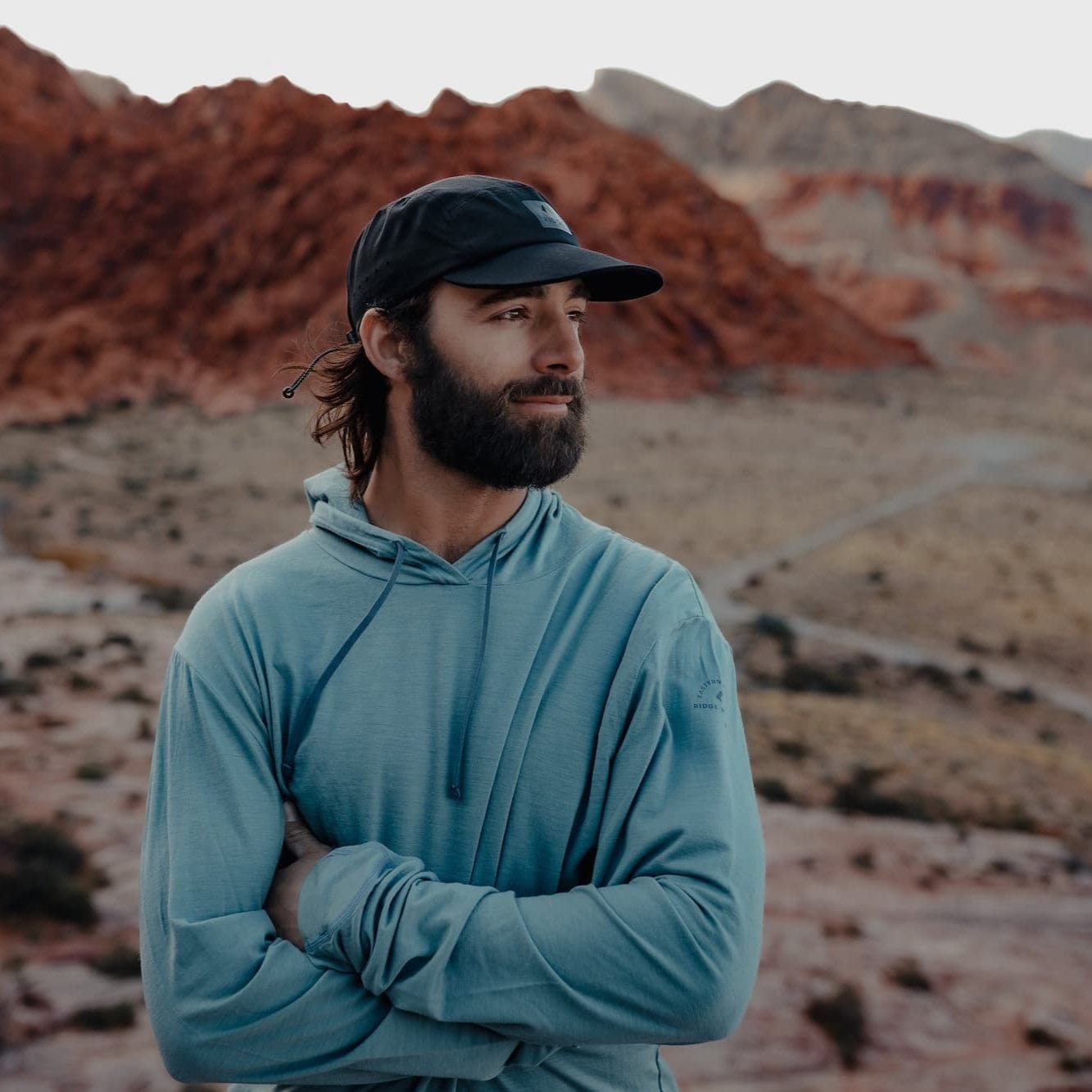 a man wearing a Solstice Lightweight Pullover Sun Hoodie and Ridge Run Hat