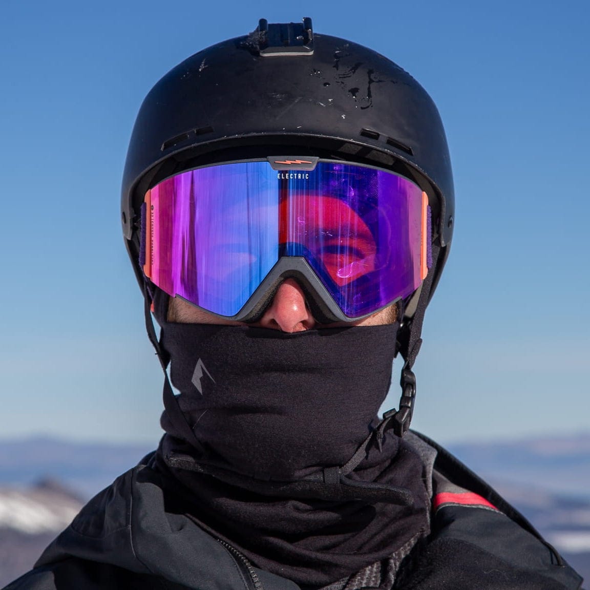 a skier wearing a ski helmet, goggles and a Ridge Merino Neck Gaiter