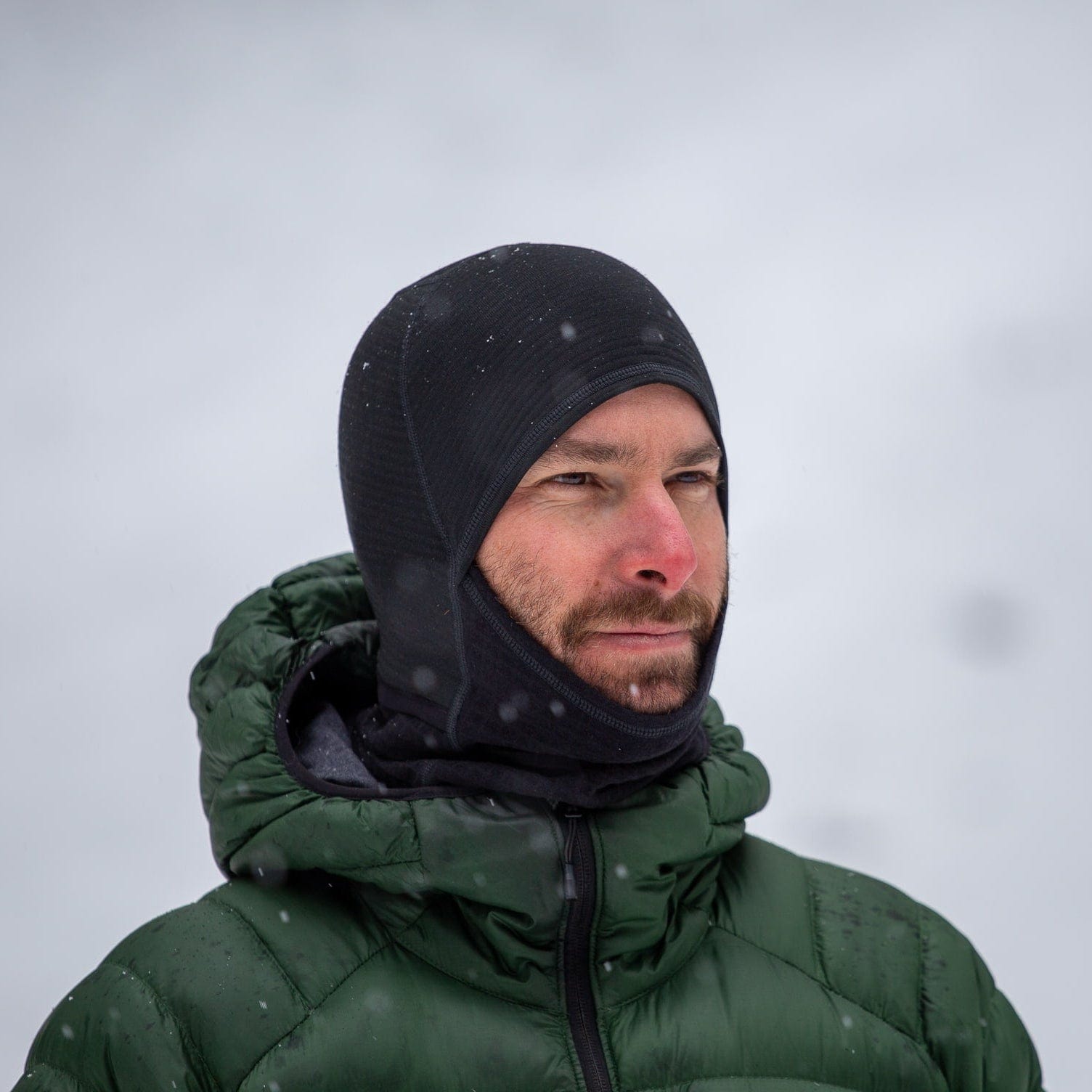 a man wearing a Ridge Merino Cloudripper Grid Fleece Balaclava
