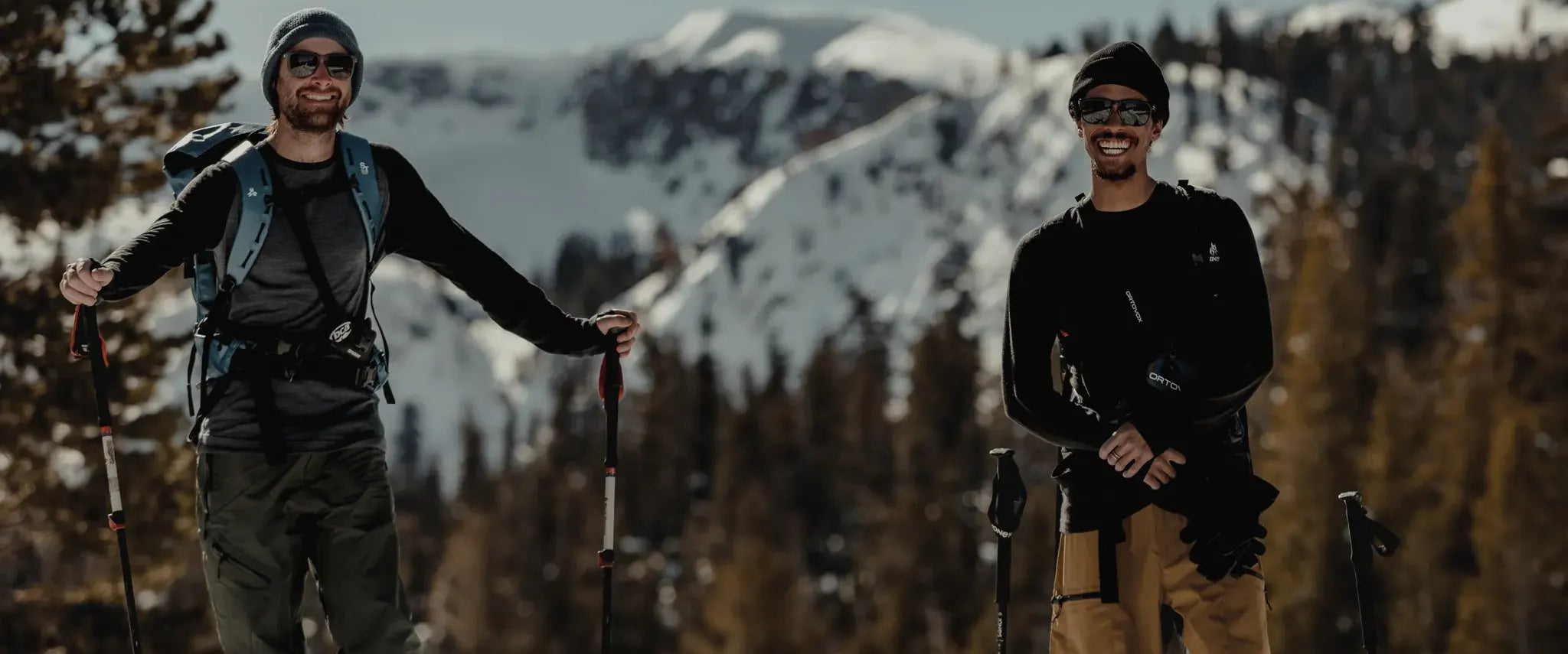 two men on a ski tour smile wearing Ridge Merino base layers
