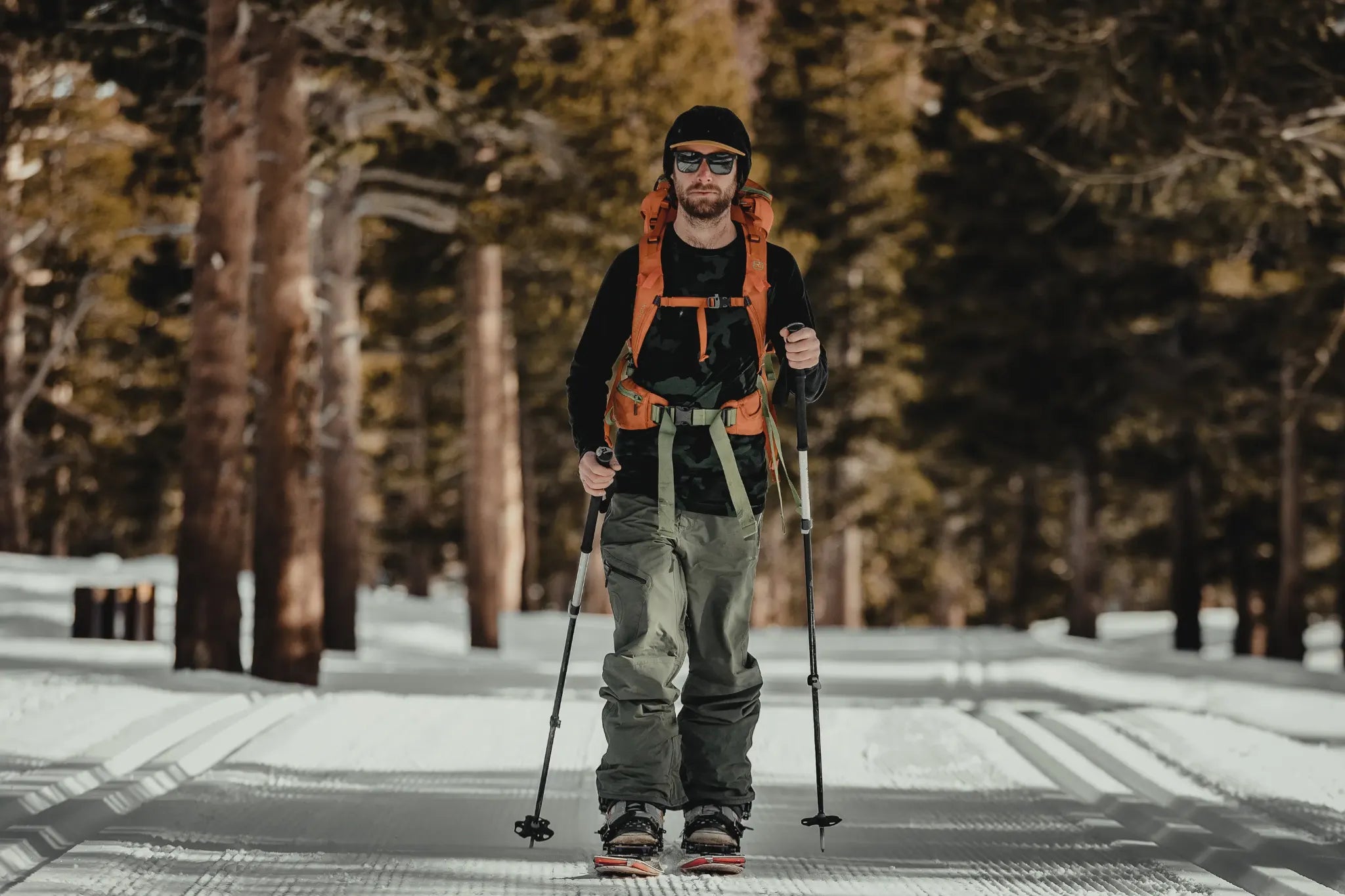 a splitboarder skins on a groomed trail in the Mammoth Lakes area
