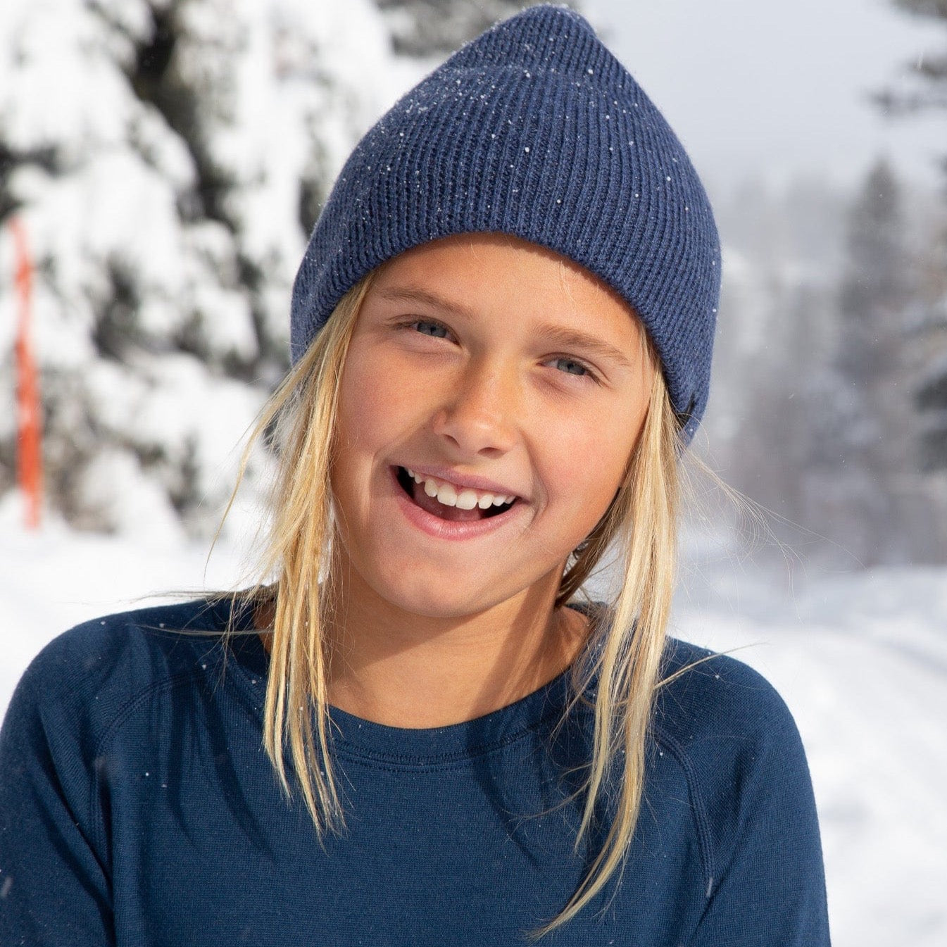 a girl wearing a Kids' Layton Merino Wool Beanie in the snow