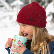 a girl wearing a Kids' Layton Merino Wool Beanie in the snow