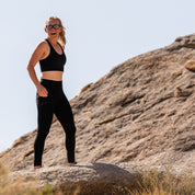 a woman laughs wearing a Ridge merino wool seamless sports bra and Crowley Compression Tights