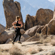 a woman running in the Alabama Hills in a Ridge Merino wool sports bra and Crowley Compression Tights