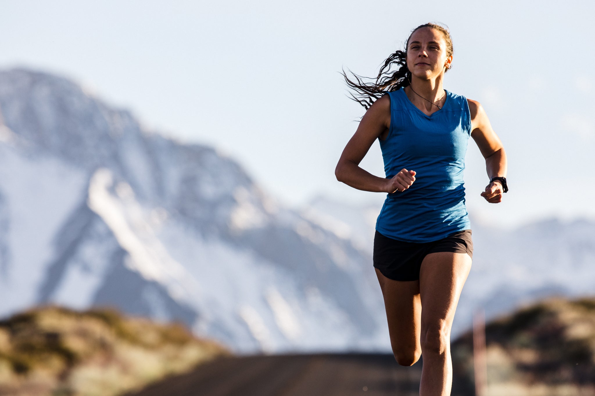 a woman running in the Eastern Sierra in a Ridge Merino tank top