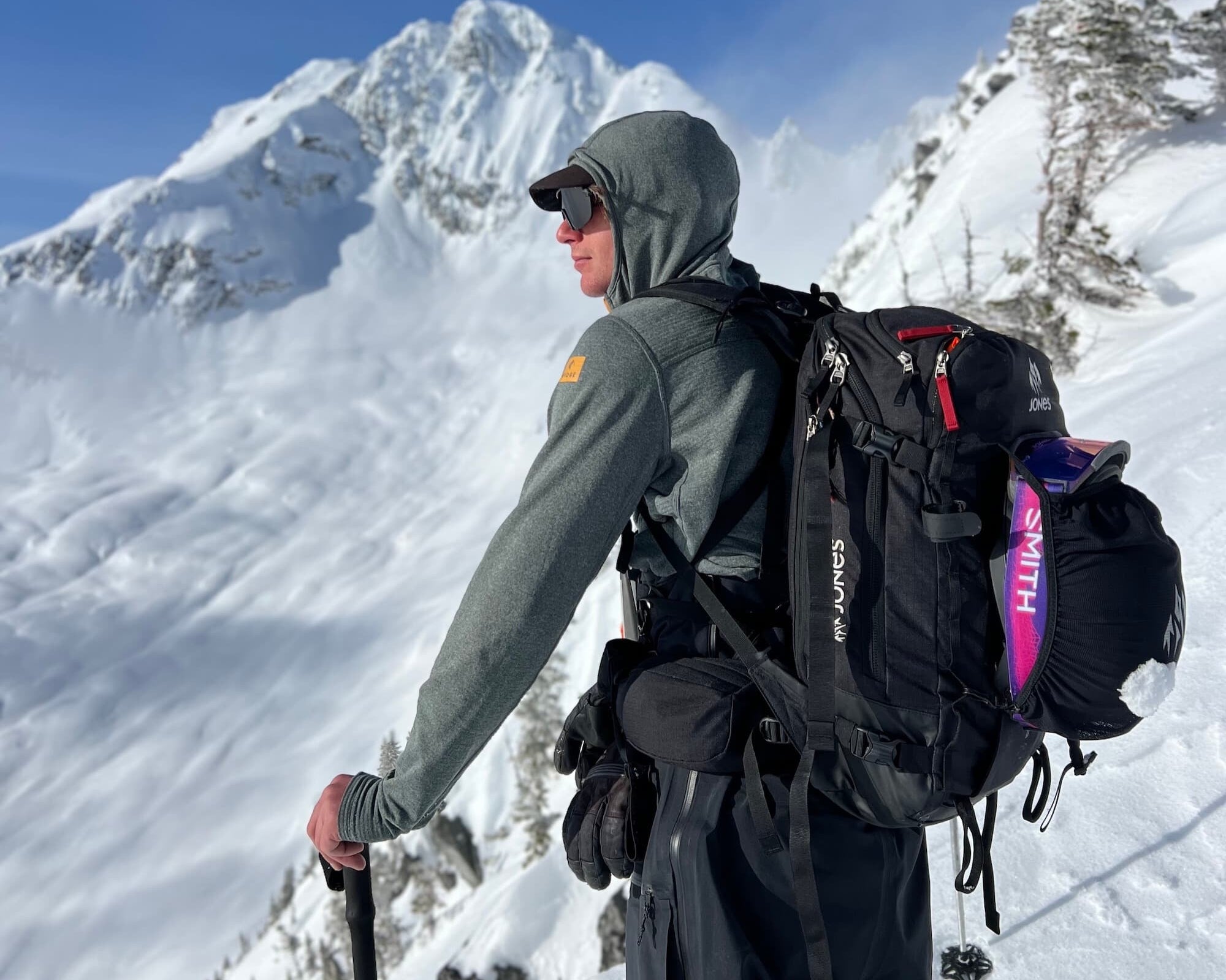 a backcountry skier in Canada wearing a Convict Canyon Hoodie with a hat and sunglasses