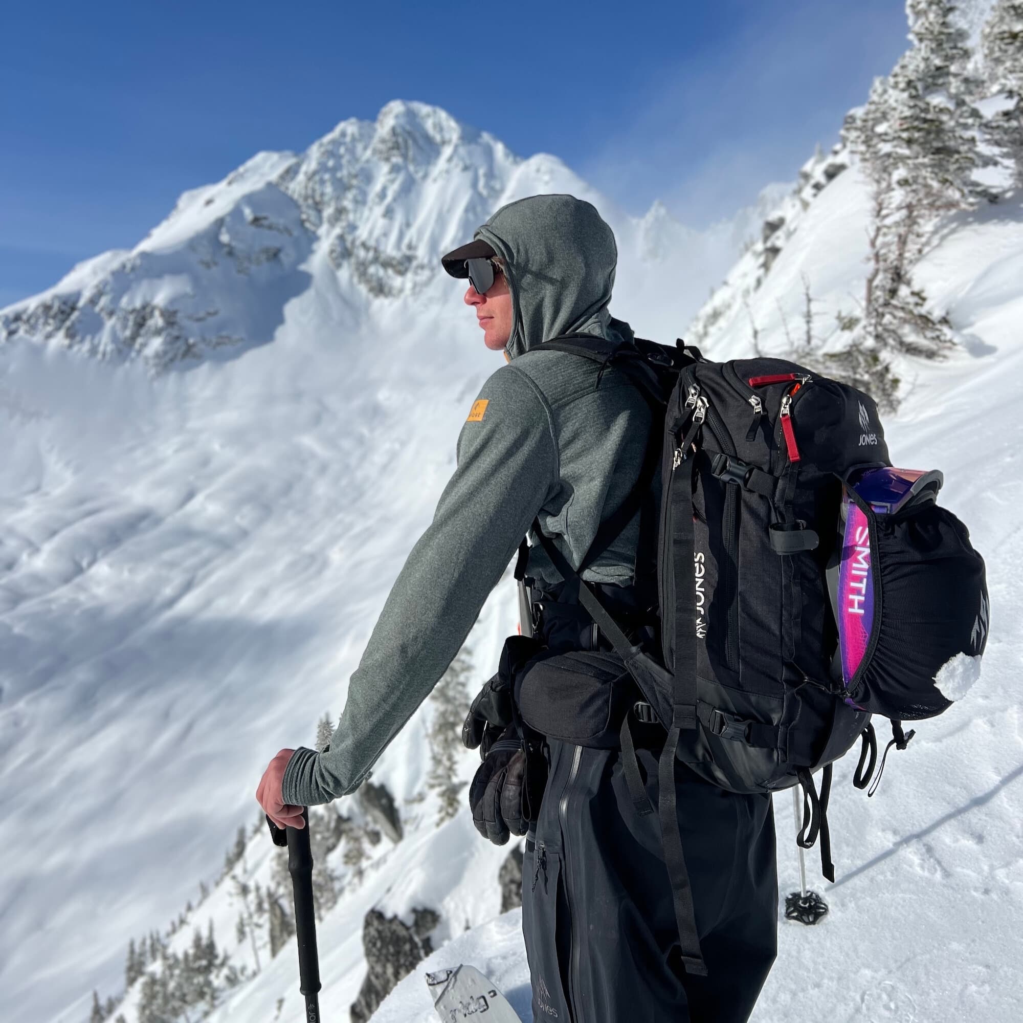 a backcountry skier in Canada wearing a Convict Canyon Hoodie with a hat and sunglasses