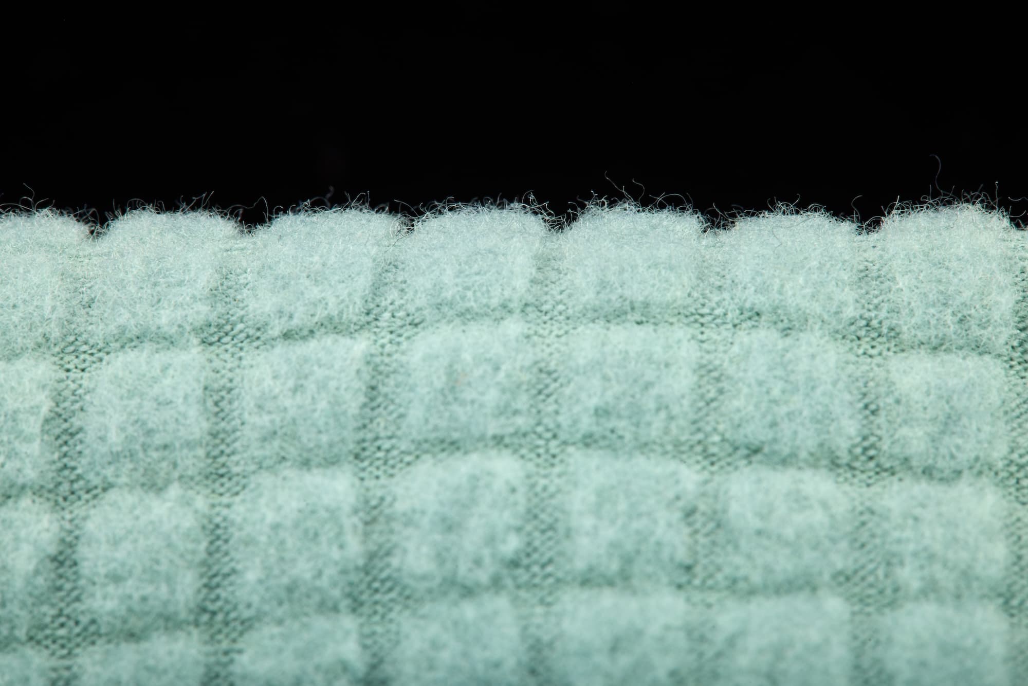 a closeup of Ridge's new Wool Grid Fleece fabric used in the Cloudripper Grid Fleece Mid Layer Collection