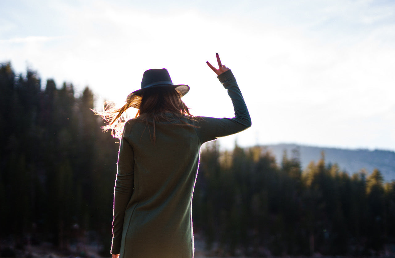 a woman doing a peace sign wearing the all natural, chemical-free, long sleeve, 100% Merino Wool Hyde Sweater Dress