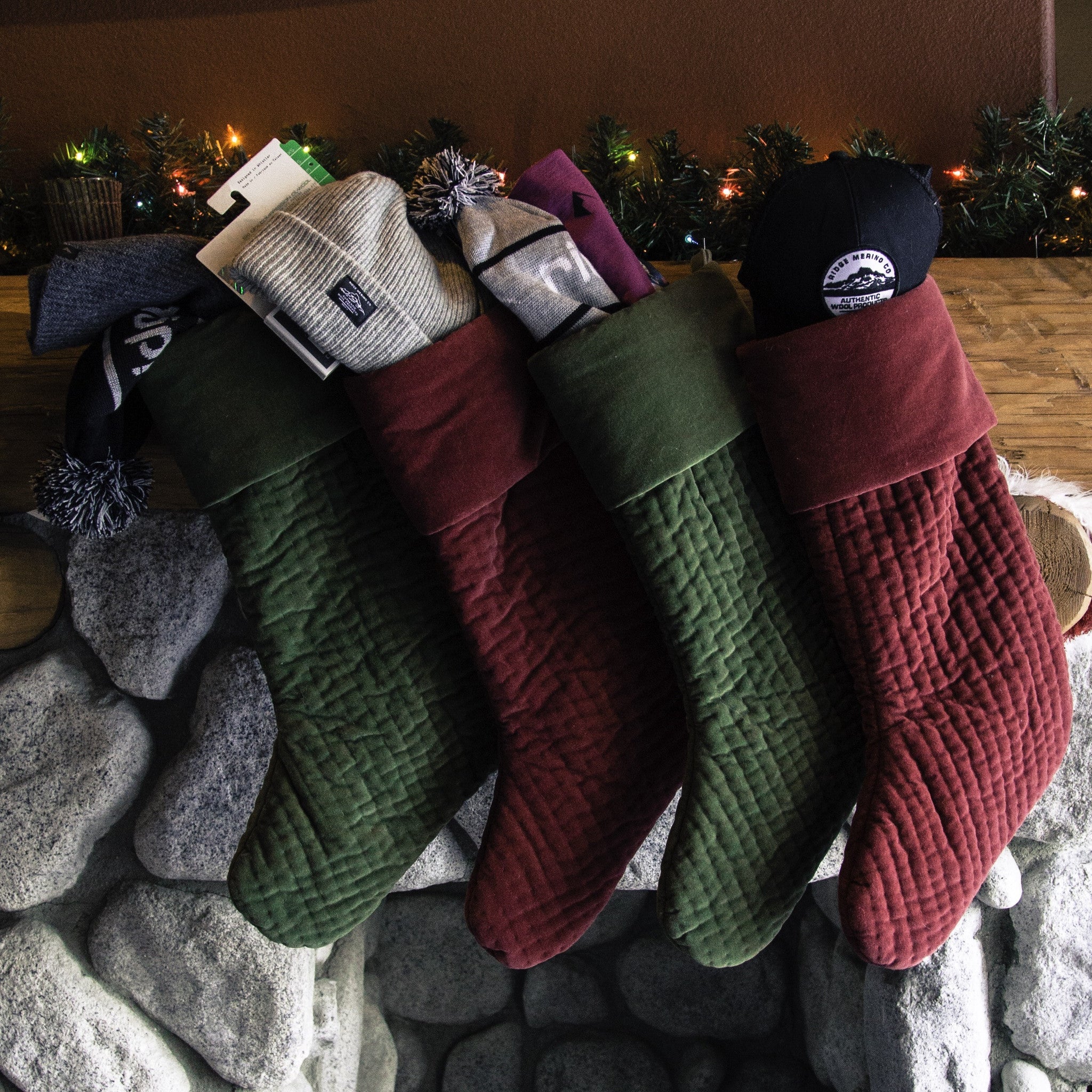 Ridge Merino accessories stuffed in stockings on a mantle