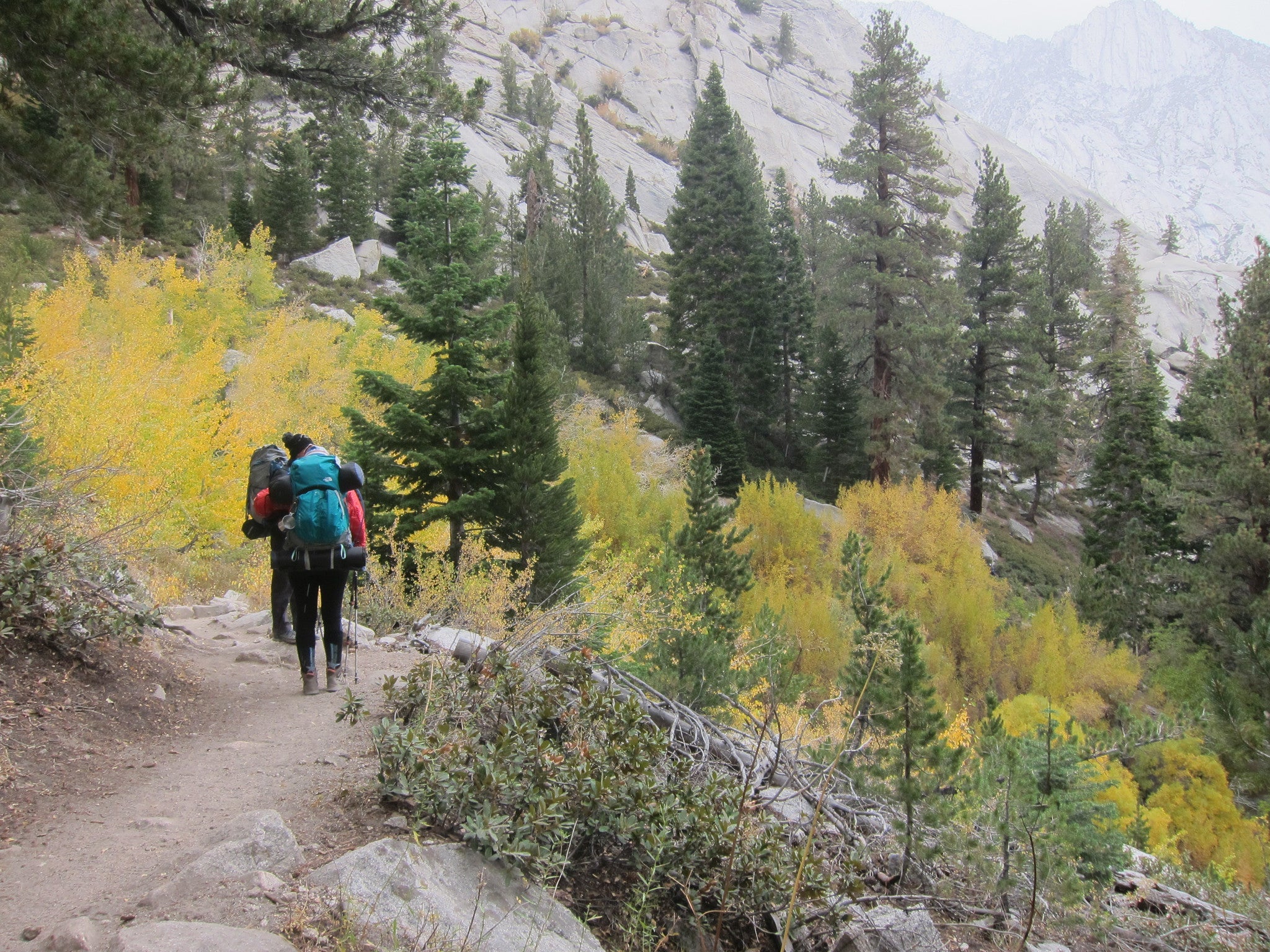 two backpackers heading out on a backpacking trip in autumn