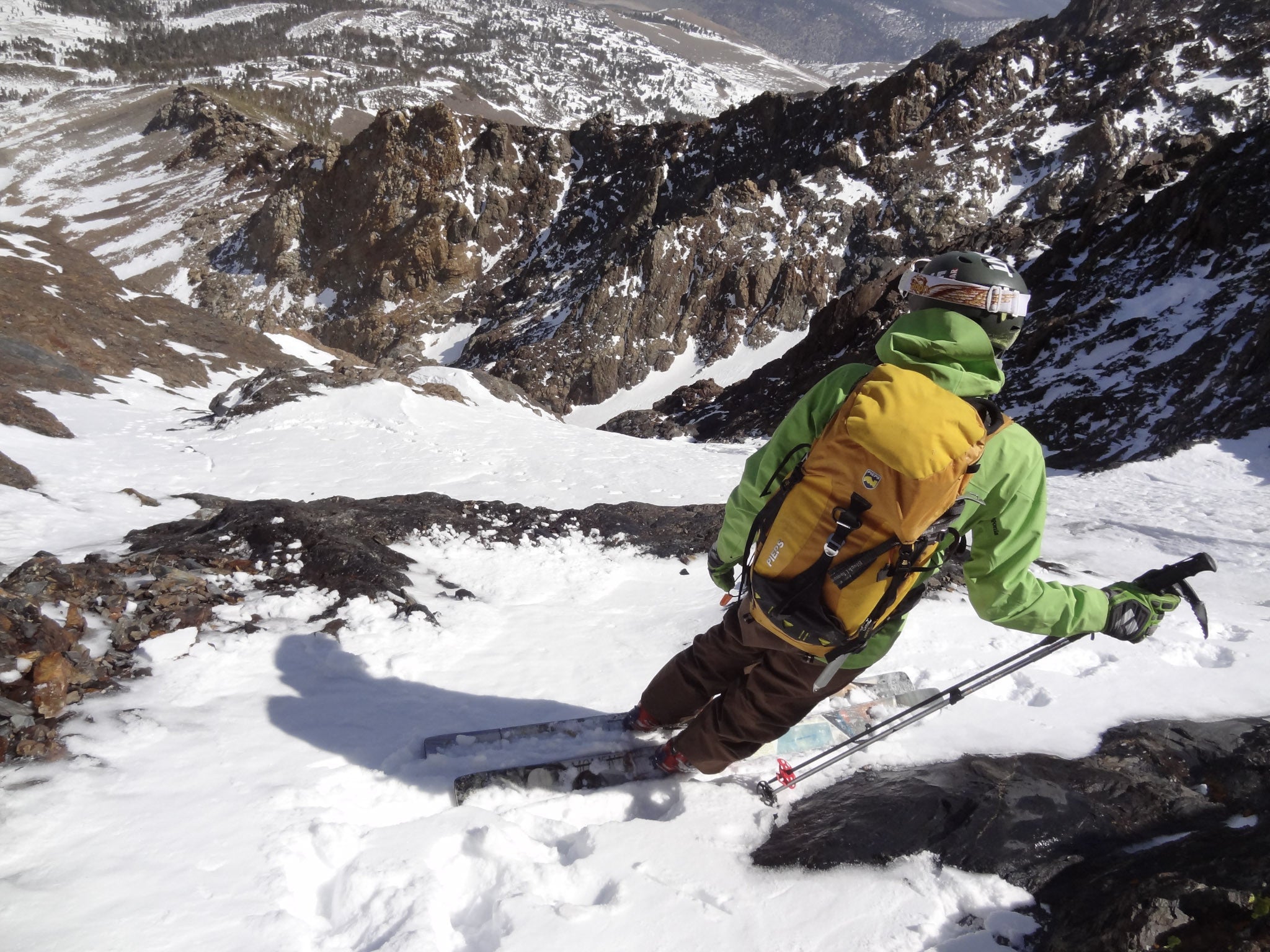 a man looks down at a ski run before sending it