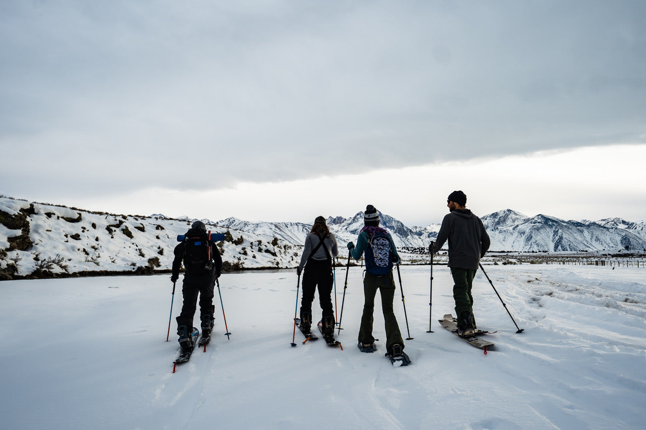 four people ski touring to a hot spring in Mammoth Lakes, CA