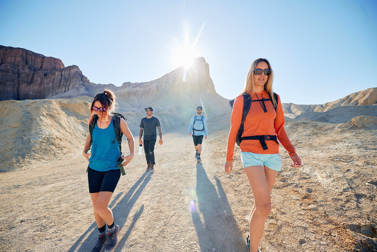 four friends hiking together in the desert