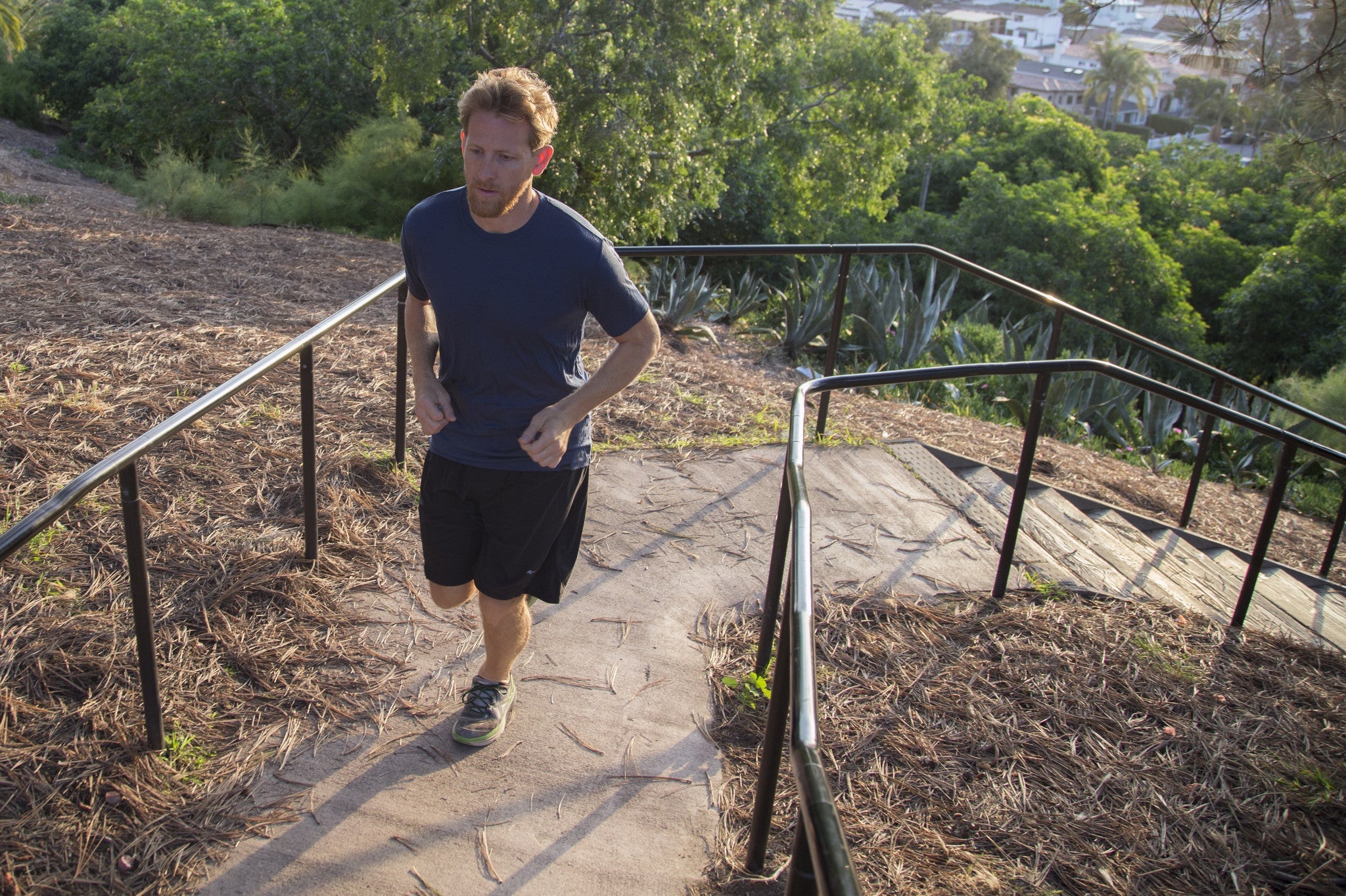 a man running up a staircase in a Ridge Merino summerweight Merino tee