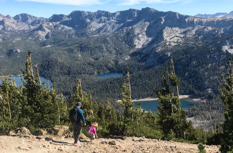 a dad following his child while out hiking in Mammoth Lakes, CA