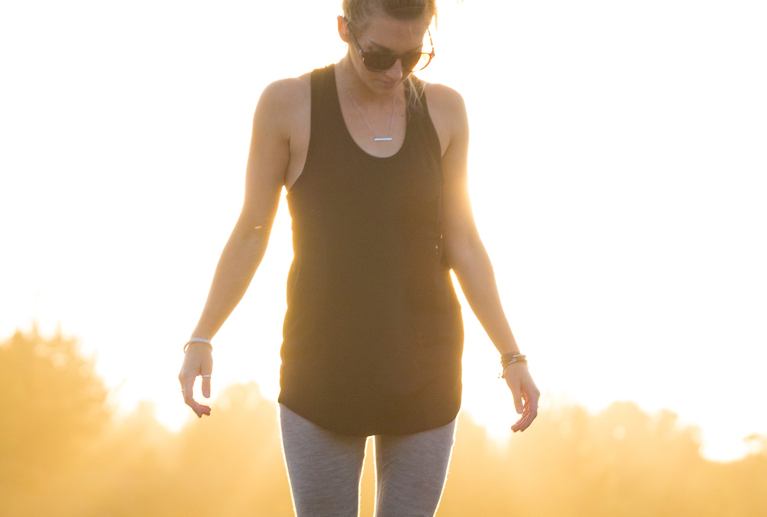 a woman wearing a Ridge Merino tank top