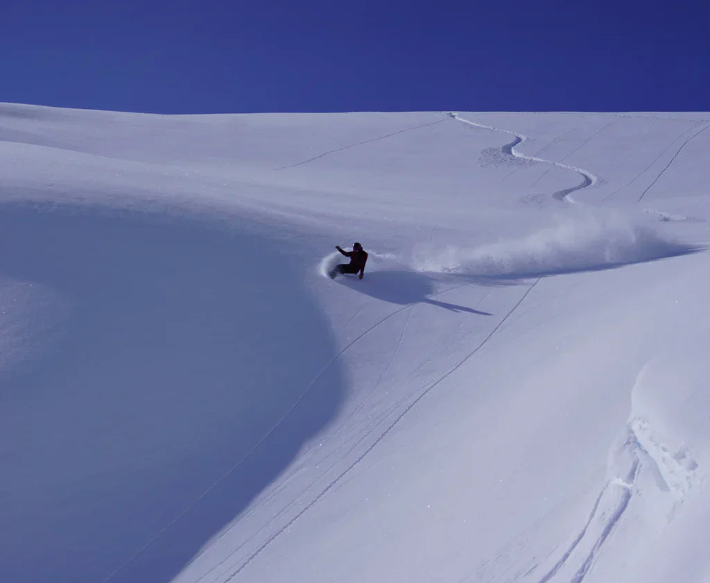 a skier making tracks down a hill