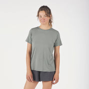 a woman wearing a green Journey Merino Wool T-shirt with running shorts