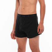 a man wearing black Ridge Merino Boxer Shorts