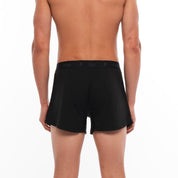 a man wearing black Ridge Merino Boxer Shorts from the back