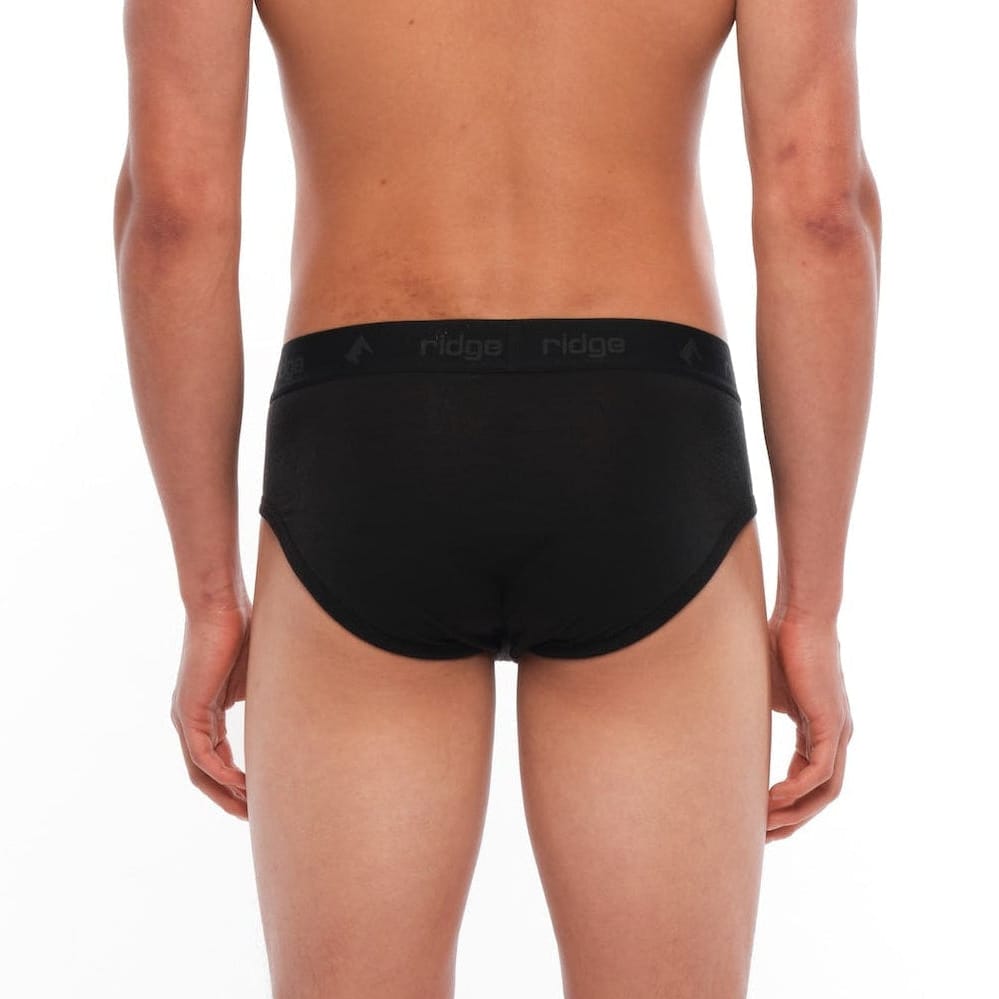 a man wearing black Merino wool briefs